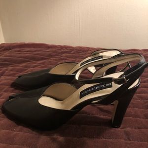 Details black, leather heels. 3 1/2 inch heels. Open toe, straps around ankles.